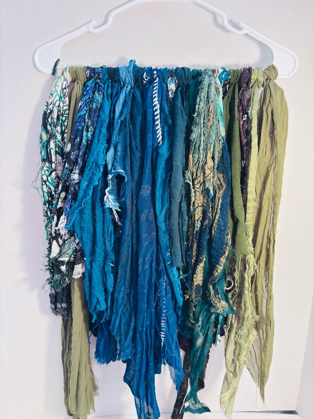 Vibrant sari silk fabric strands in blue/green hues.Junk journal sewing.